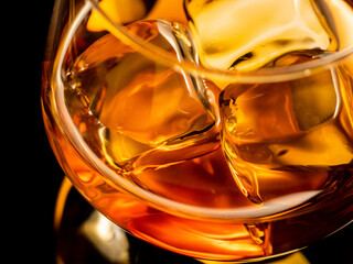 Whisky on the rocks, glass filled with ice cubes