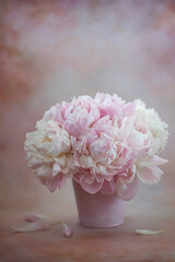 Bouquet of peonies in a vase on a gentle retro background