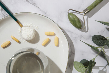 Collagen powder and pills in spoon. Concept of nutritional supplement for skin beauty