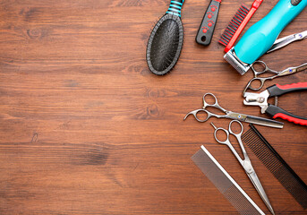 set of pets grooming tools on a wooden background