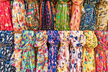 Rows of colorful silk scarfs background
