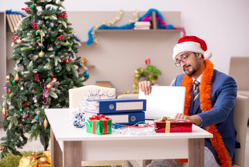 Young businessman working from home at Christmas eve