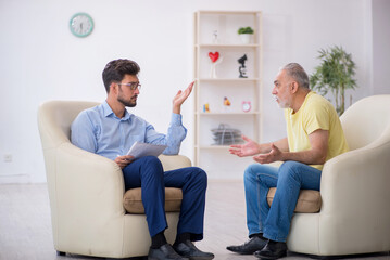 Old man visiting young male psychotherapist