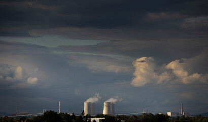 A nuclear power plant on which the sun shone as a source of ecological electricity - obrazy, fototapety, plakaty