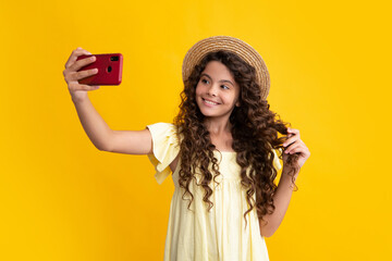 Kids selfie. Portrait of cute teenage girl using mobile phone, chatting on web, typing sms message. Mobile app for smartphone. Happy teenager, positive and smiling emotions of teen girl.