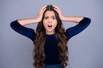 Angry face, upset emotions of teenager girl. Children studio portrait on yellow background. Childhood lifestyle concept. Cute teenage girl face close up.