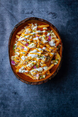 Poke bowl with quinoa salmon avocado and feta cheese on a dark background closeup