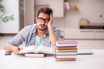 Young male student preparing for exams at home