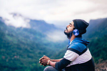 person listening music in the mountains