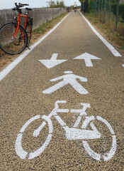 cycle path in the Plains with the symbol of arrows to indicate the direction of travel for bicycles and a bicycle parked alongside