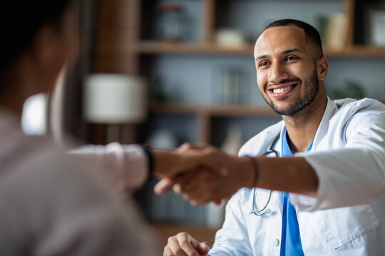 Handsome Arabic Doctor Shaking Female Patient Hand