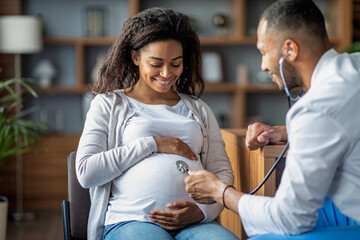 Pregnant african american woman visiting doctor gynecologist
