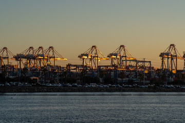 Fototapeta na wymiar San Pedro, LA, California, CA, USA - July 10, 2022: View of Port of Los Angeles and Container Terminal after sunset. The Port of Los Angeles is a seaport managed by the Los Angeles Harbor Department. 