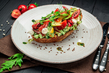 Bruschetta with sun-dried tomatoes, cream cheese, avocado and fresh vegetables.