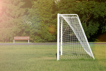 Soccer goal. View of the net on an empty football field. Football goal on the football field on the side.