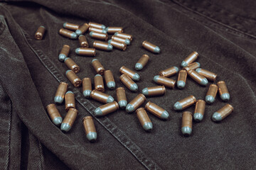 .45 ACP cartridges on a black denim background