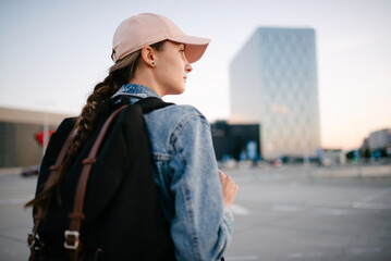 Tourist girl with her backpack looking at city landscape, back view Adventure and travel in the concept . Backpack rear view. Tourism in city. - 518193470