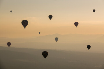 Group of Hot Air Balloons Flying Over Ancient Pyramid of Teotihuacan, Mexico at sunrise -sunset,...