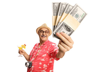 Happy mature male tourist holding a cocktail and showing money