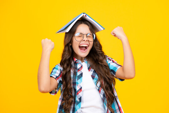 Amazed teen girl. Teen girl pupil hold books, notebooks, isolated on yellow background, copy space. Back to school, teenage lifestyle, education and knowledge. Excited expression, cheerful and glad.