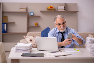 Old male boss working from home during pandemic
