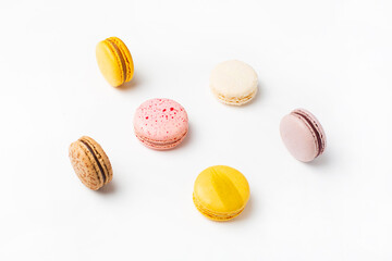 Macaroons sweet food on white background. Pastel yellow, pink color background. 