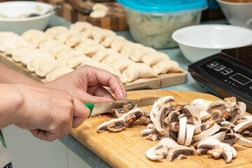 Hands Preparing mushrooms to Fry with Pierogies
