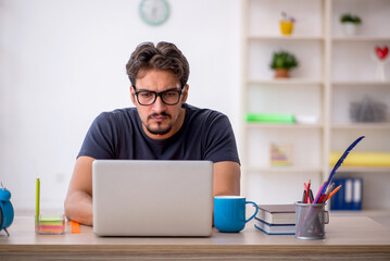Young male designer working in the office