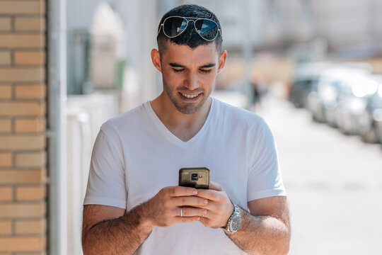 Portrait Of Middle Aged Man Looking At Mobile Phone