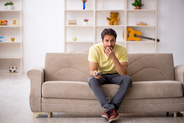 Young man sitting at home during pandemic