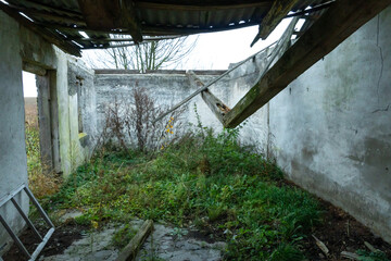 An old ruined building without windows and doors in the middle of the field. Autumn utopian...