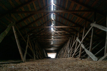 Abandoned ruined barn cowshed inside view. The old abandoned barn with the remains of feeders. barn from inside with low light © Pokoman