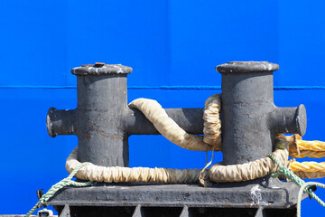 Mooring bollard on a wharf for ship's rope. The mooring line on the ship's bollard
