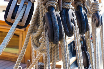 Old wooden deadeye on the shrouds of a sailing vessel. Ship rigging, shrouds of an old wooden ship