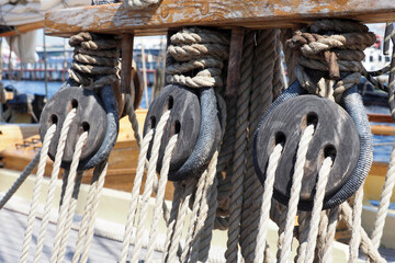 Ship rigging, shrouds of an old wooden ship. Old wooden deadeye on the shrouds of a sailing vessel...