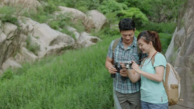 Happy young Chinese couple taking photos outdoors,4K