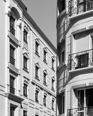 A vertical shot of buildings in black and white.