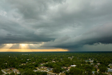 Landscape of dark ominous clouds forming on stormy sky before heavy thunderstorm over rural town...