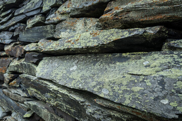 stone wall background from weathered slate stones