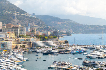 Luxury yachts line the harbor during Grand Prix Race day at Monte Carlo, Monaco, with the...