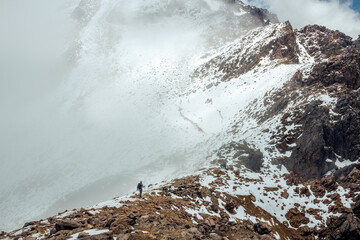 Male Mountain Climber Walking Uphill On Frozen Snow in izitaccihuatl volcano