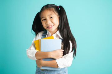 Close-up kid students girl smiling holding book, going to school.