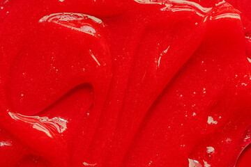 Red gel texture. Cosmetic clear liquid cream smudge. Skin care product sample closeup. Toothpaste...