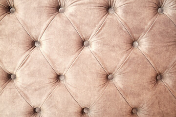 Background texture of draped sofa back with velveteen and buttons. Abstract interiors backgrounds