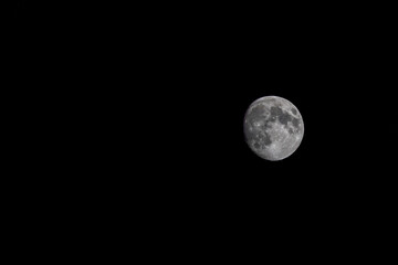 Near Full moon in sea of black, large moon in night sky, dark sky with big moon
