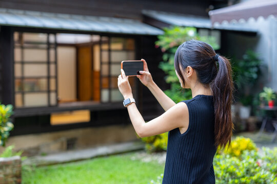 Woman use mobile photo to take photo in Japanese house