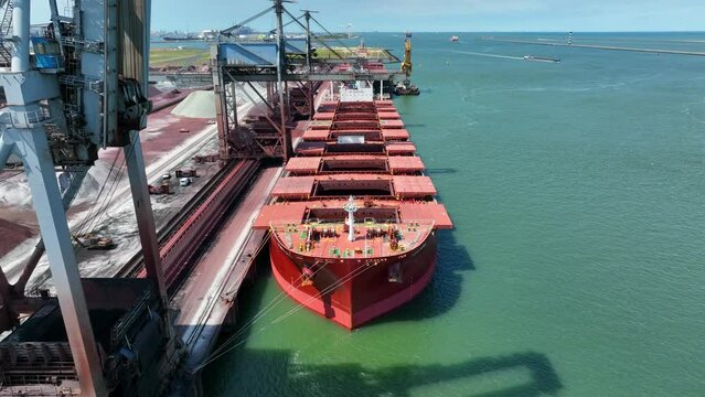 Bulk Carrier Ship Offloading Cargo By Crane for Processing