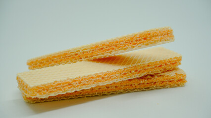 Tasty wafer sticks on white background, flat lay. Sweet food
