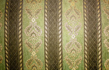 Old green matter pattern texture. Patterned sofa fabric. Golden embroidery on green fabric. Sofa...