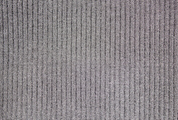 Black knitted warm fabric texture. Woolen winter warm knitted fabric.Knitted black wool background....